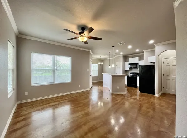 a view of a big room with windows and a kitchen