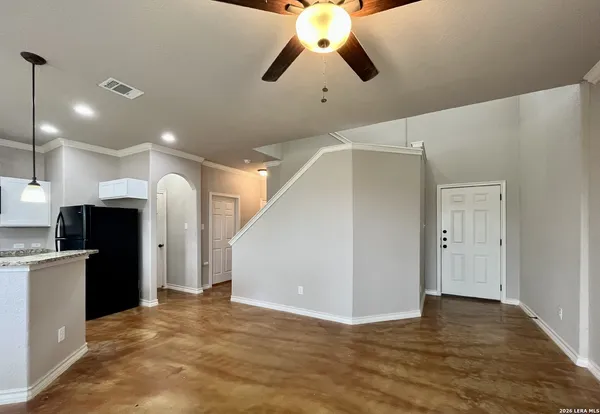 a view of a kitchen with a refrigerator and a chandelier