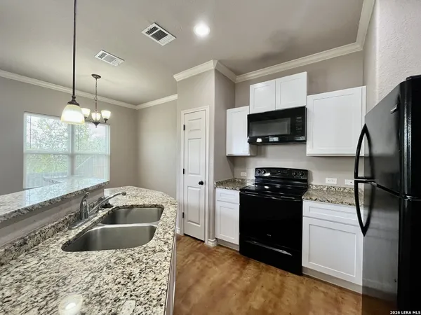 a kitchen with a sink stove and refrigerator