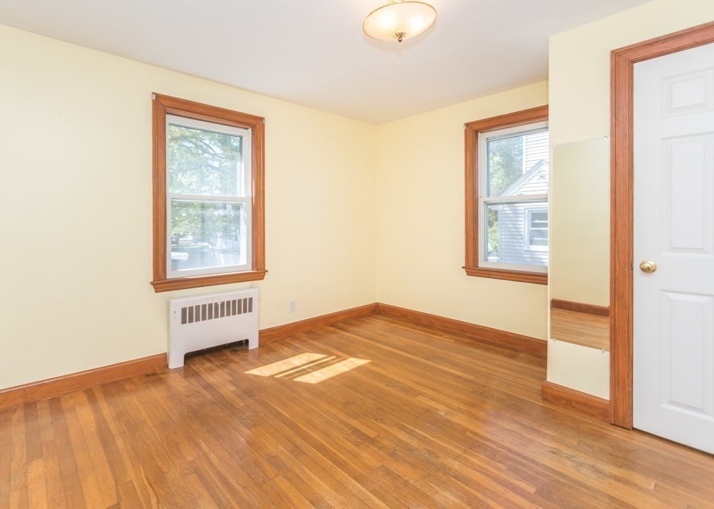 1172 Trapelo Road Waltham, MA 02451 - Photo 11 of 25 an empty room with wooden floor and windows