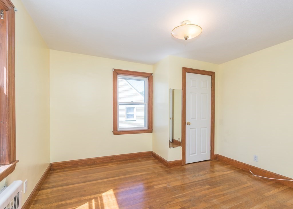 1172 Trapelo Road Waltham, MA 02451 - Photo 12 of 25 a view of an empty room with wooden floor and a window
