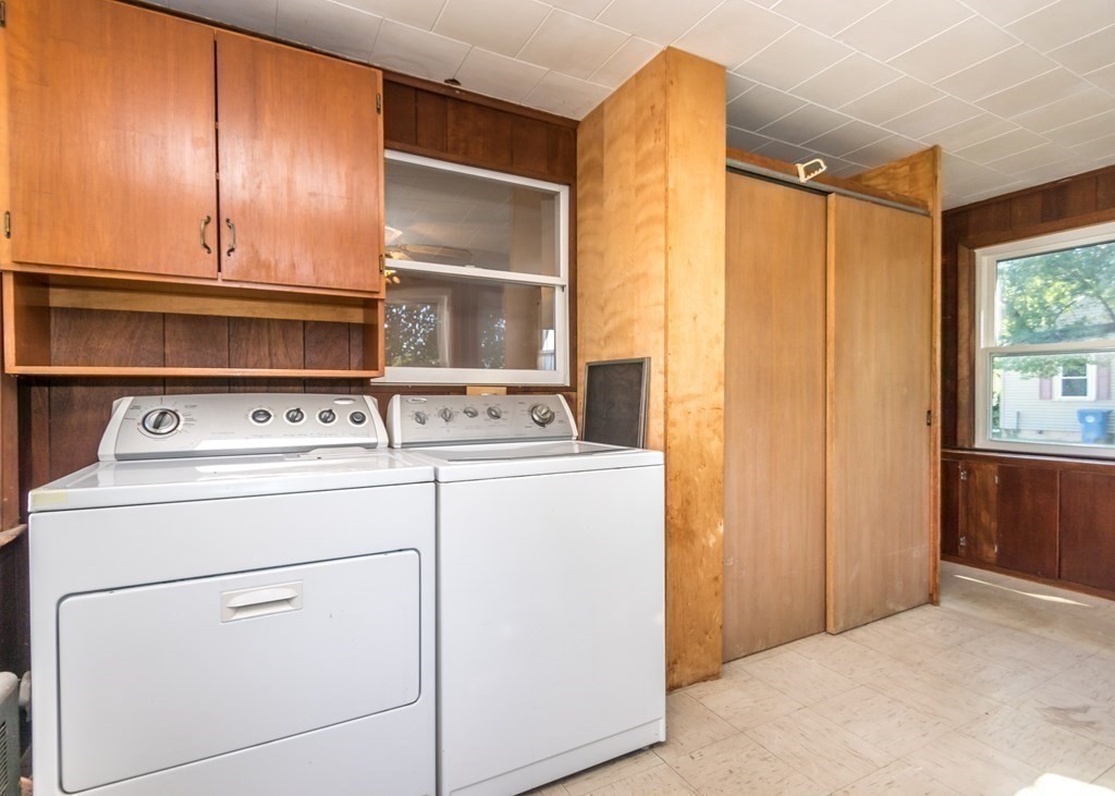 1172 Trapelo Road Waltham, MA 02451 - Photo 18 of 25 a view of washer and dryer with kitchen in the background