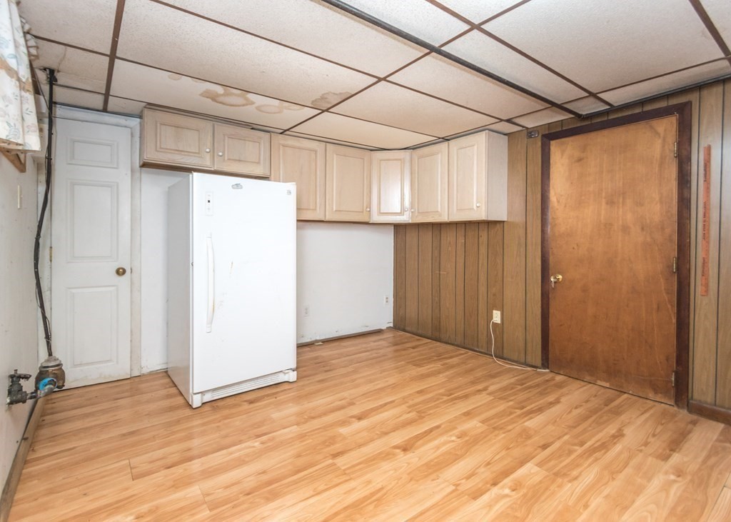 1172 Trapelo Road Waltham, MA 02451 - Photo 21 of 25 a view of a room with a wooden floor and refrigerator