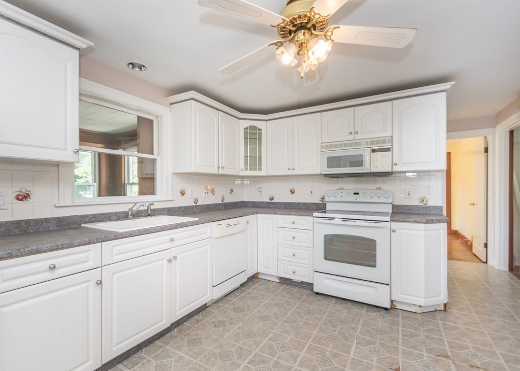 1172 Trapelo Road Waltham, MA 02451 - Photo 4 of 25 a kitchen with stainless steel appliances granite countertop a stove sink and cabinets