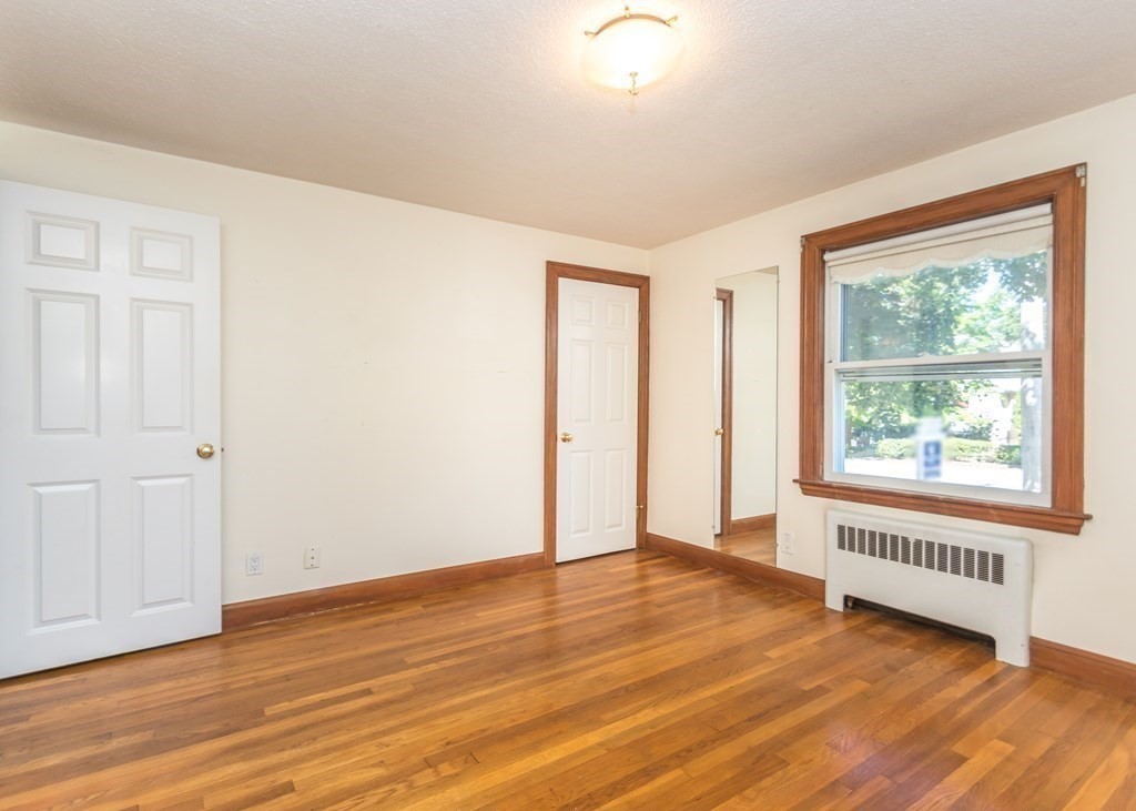 1172 Trapelo Road Waltham, MA 02451 - Photo 6 of 25 an empty room with wooden floor and windows