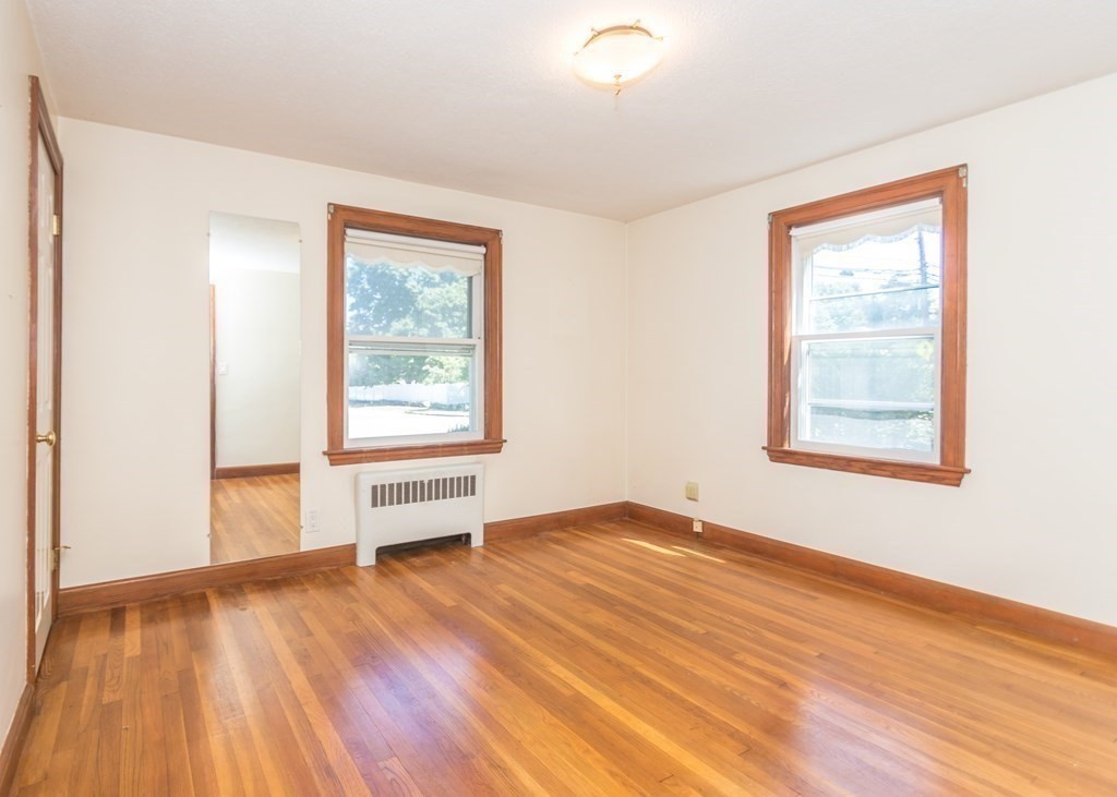 1172 Trapelo Road Waltham, MA 02451 - Photo 7 of 25 an empty room with wooden floor and windows