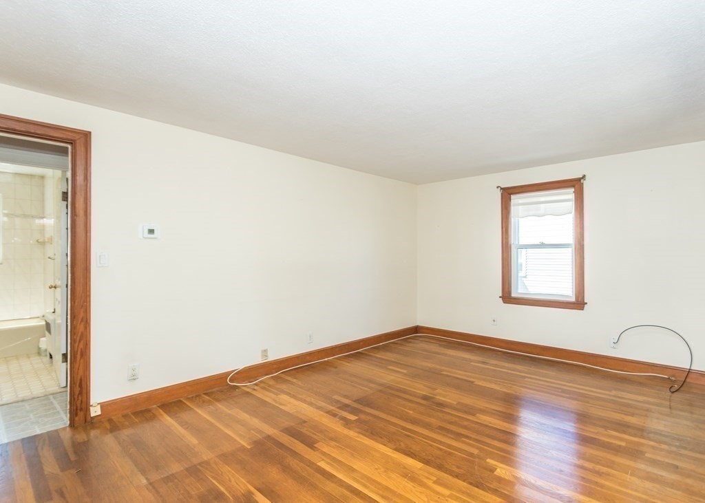 1172 Trapelo Road Waltham, MA 02451 - Photo 8 of 25 an empty room with wooden floor and windows