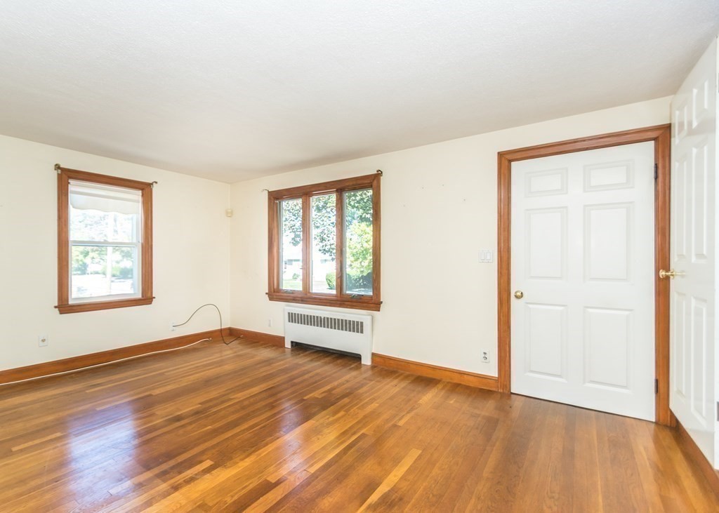1172 Trapelo Road Waltham, MA 02451 - Photo 9 of 25 an empty room with wooden floor and windows