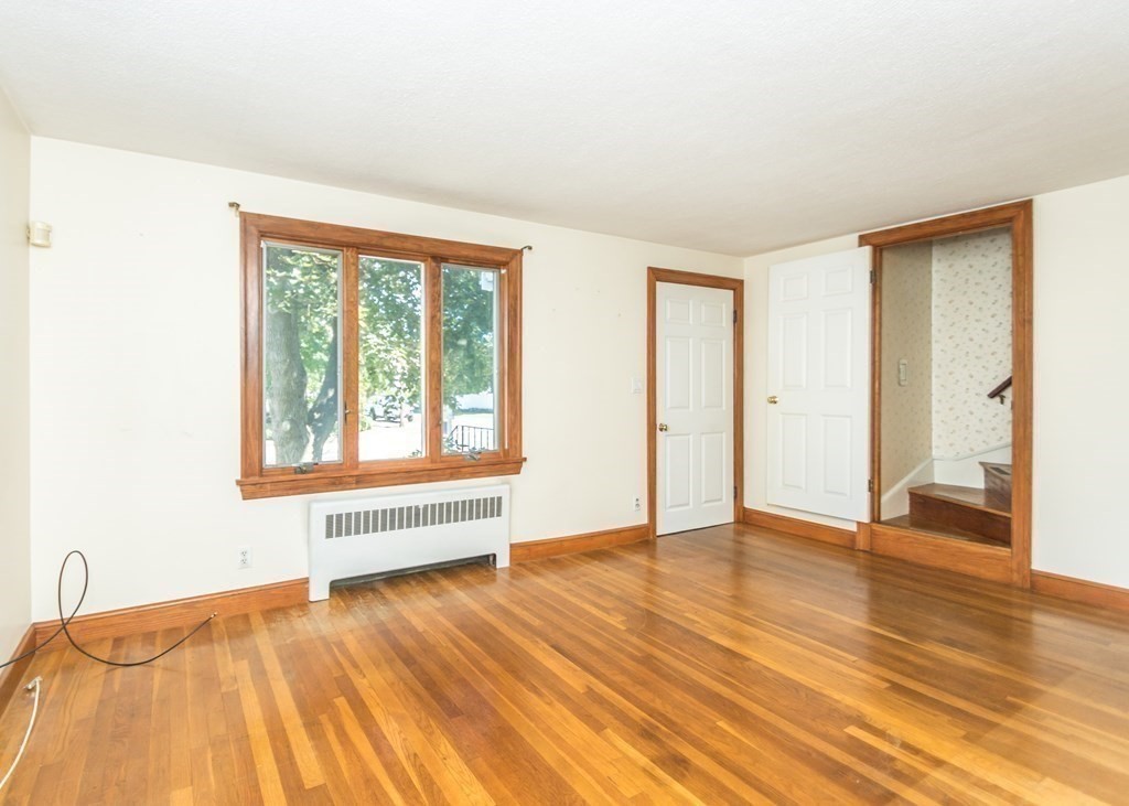 1172 Trapelo Road Waltham, MA 02451 - Photo 10 of 25 a view of an empty room with wooden floor and a window
