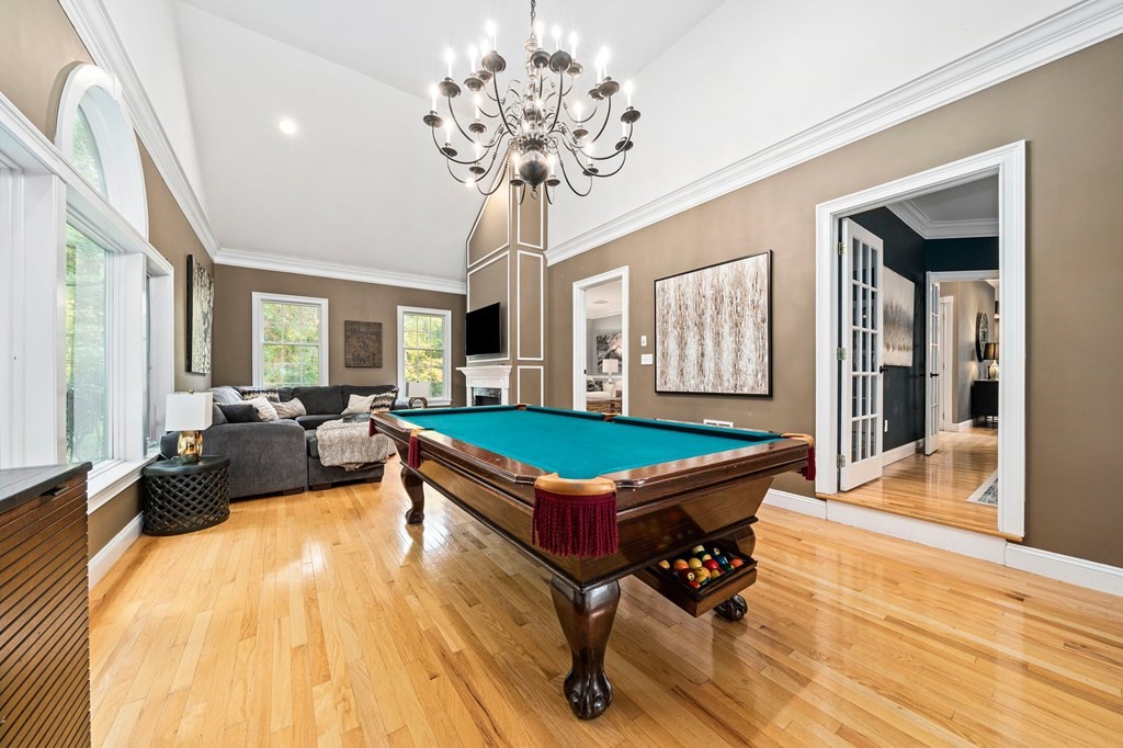 105 Waterman Road Canton, MA 02021 - Photo 14 of 39 a living room with a pool furniture and a chandelier