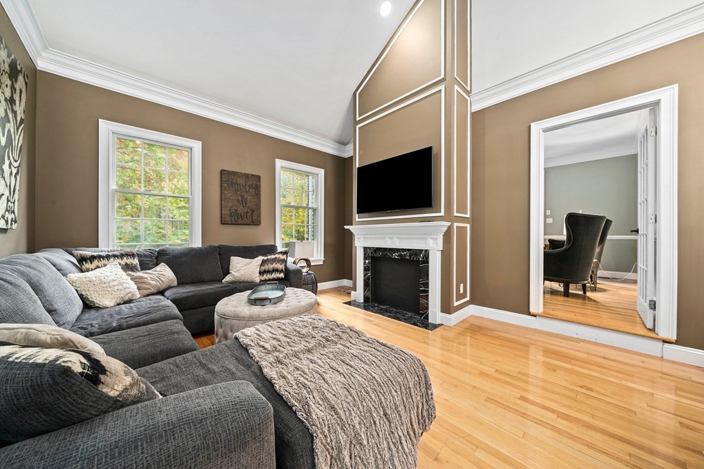 105 Waterman Road Canton, MA 02021 - Photo 15 of 39 a living room with furniture a fireplace and a flat screen tv