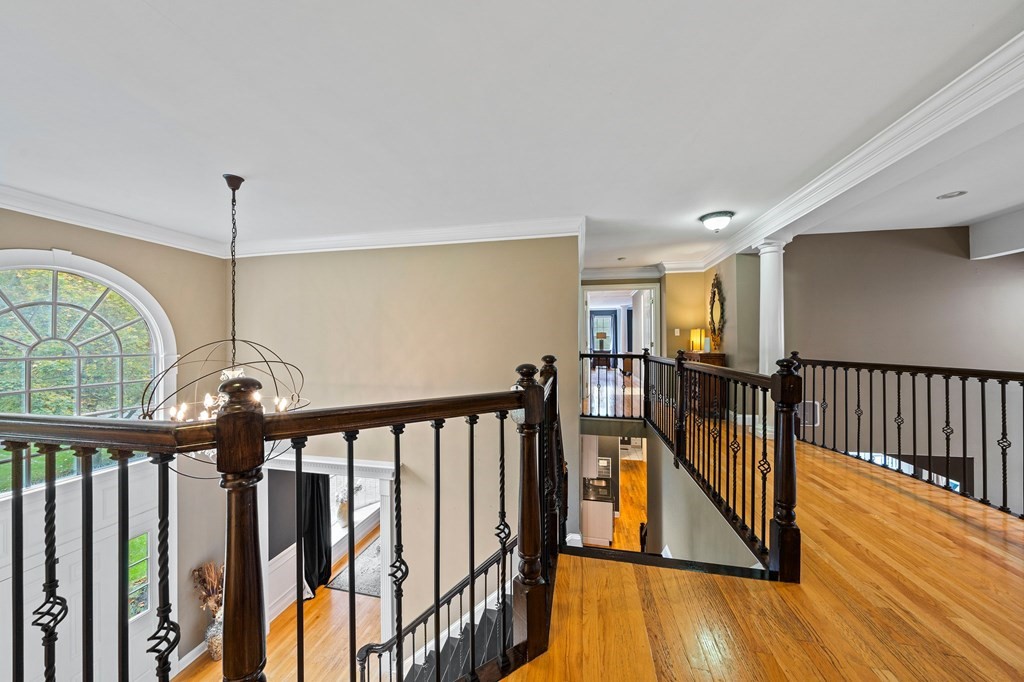 105 Waterman Road Canton, MA 02021 - Photo 21 of 39 a view of a hallway with wooden floor and stairs