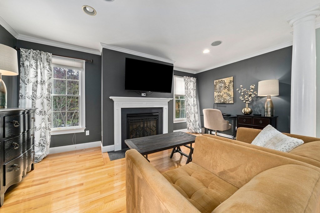 105 Waterman Road Canton, MA 02021 - Photo 23 of 39 a living room with furniture a flat screen tv and a fireplace