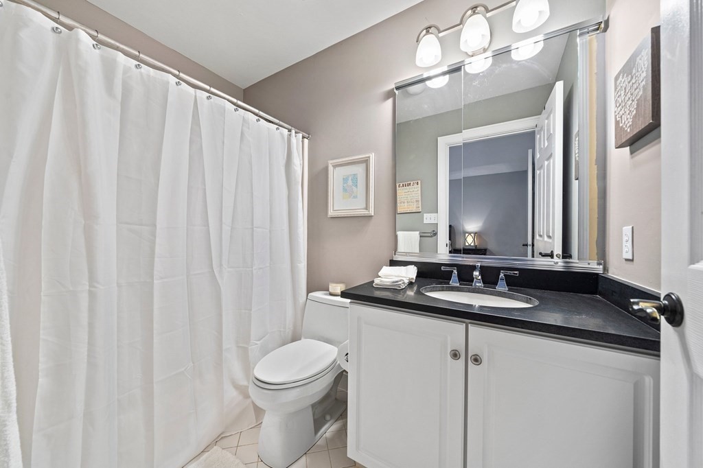 105 Waterman Road Canton, MA 02021 - Photo 27 of 39 a bathroom with a granite countertop sink and a mirror