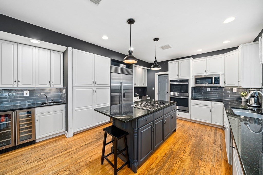 105 Waterman Road Canton, MA 02021 - Photo 3 of 39 a kitchen with stainless steel appliances kitchen island granite countertop a stove refrigerator and cabinets