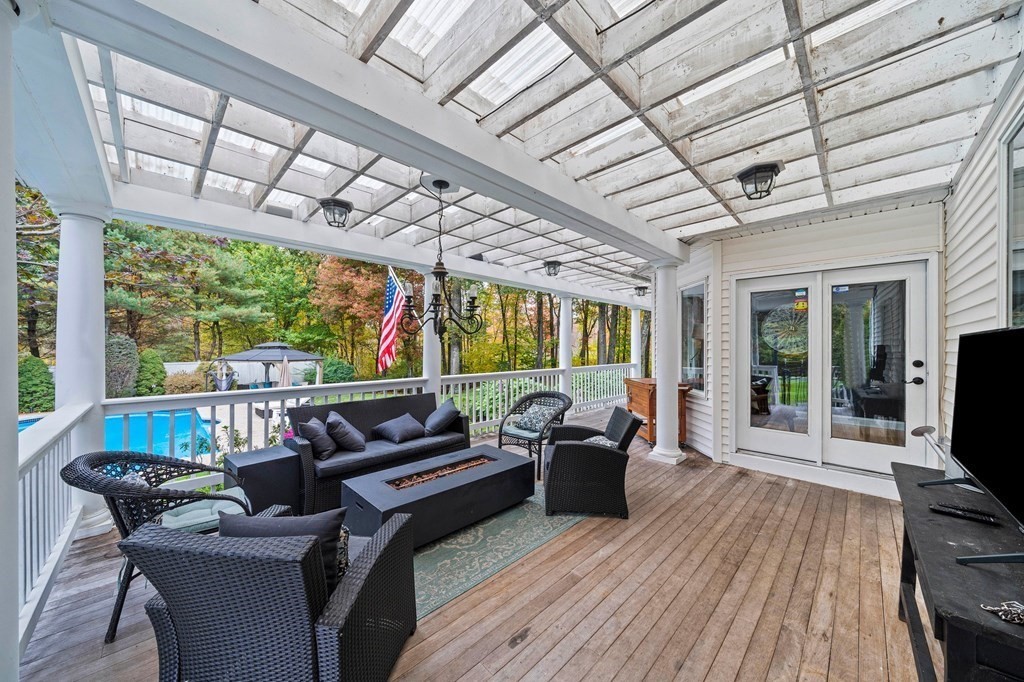 105 Waterman Road Canton, MA 02021 - Photo 32 of 39 a living room with furniture floor to ceiling window and wooden floor