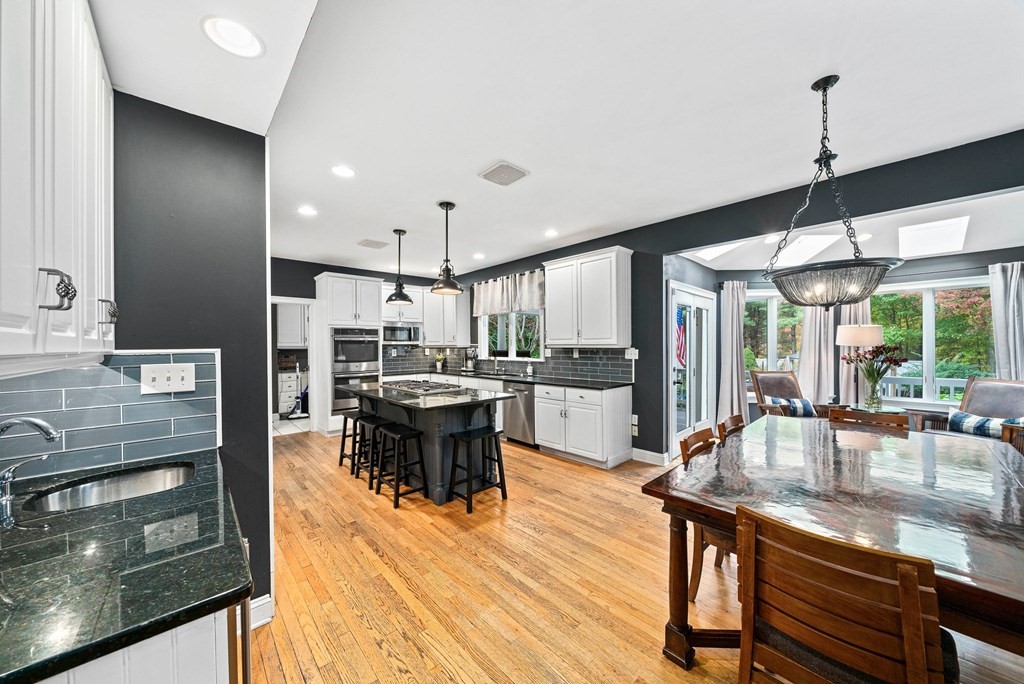105 Waterman Road Canton, MA 02021 - Photo 4 of 39 a kitchen with stainless steel appliances kitchen island granite countertop a table chairs and a view of living room