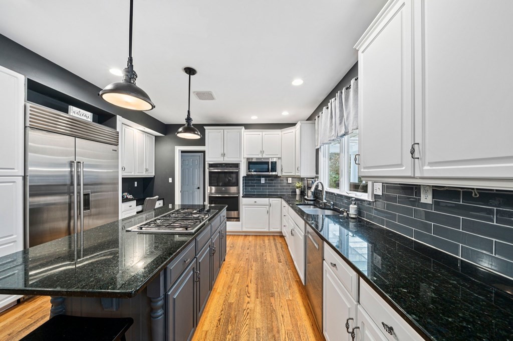 105 Waterman Road Canton, MA 02021 - Photo 6 of 39 a kitchen with stainless steel appliances granite countertop a sink a counter space and cabinets