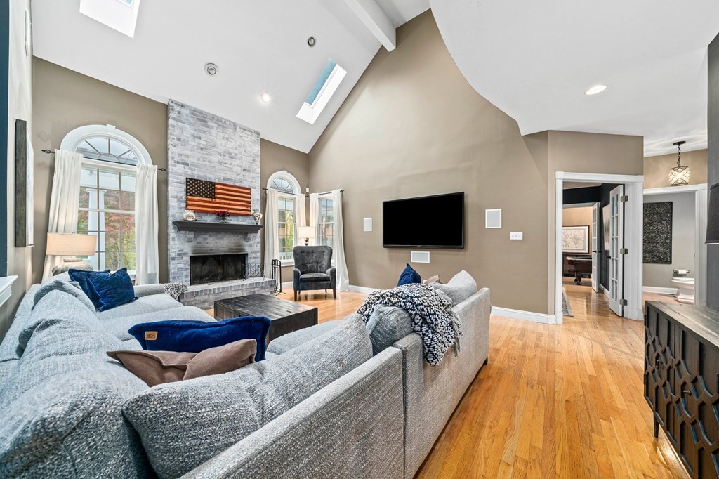 105 Waterman Road Canton, MA 02021 - Photo 9 of 39 a living room with fireplace furniture and a flat screen tv