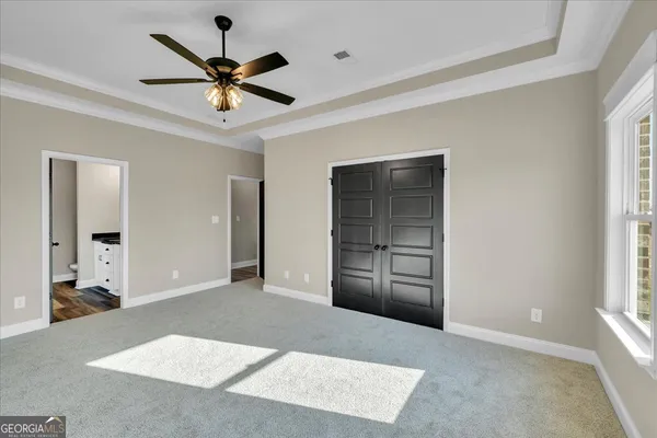 a view of a livingroom with a ceiling fan and window