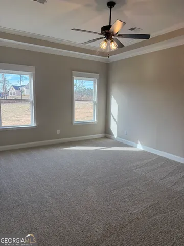 a view of a livingroom with a ceiling fan and window