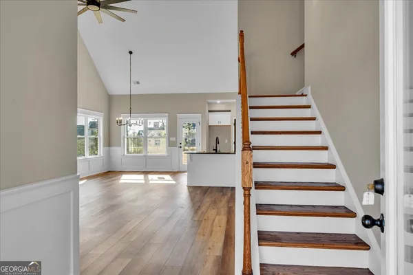 a view of entryway and hall with wooden floor