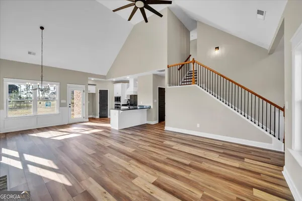 a view of empty room with wooden floor