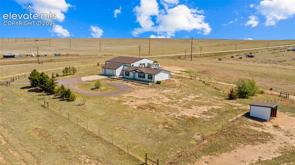 33975 Highway 94 Yoder, CO 80864 - Photo 30 of 40 Spacious property featuring a single-story residence with an attached garage, a separate outbuilding, and a circular driveway