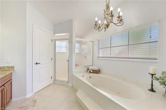 a bathroom with a bathtub a sink and a window