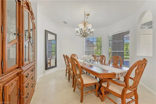 a view of a dining room with furniture and chandelier
