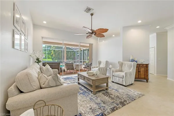 a living room with furniture ceiling fan and a rug