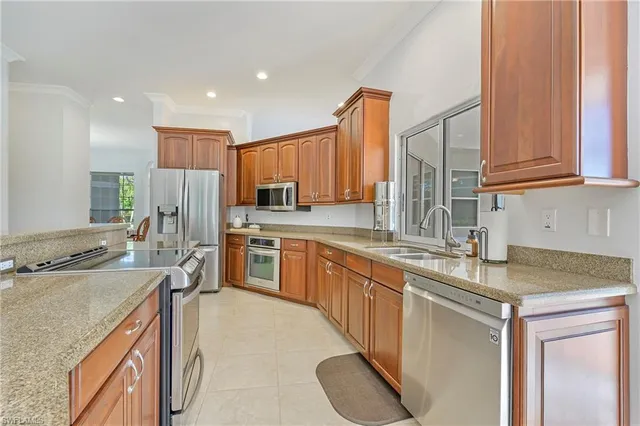 a kitchen with stainless steel appliances granite countertop a sink stove and cabinets