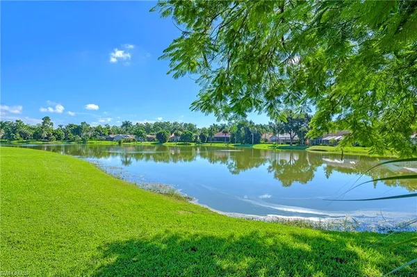 a view of a lake with houses in the back