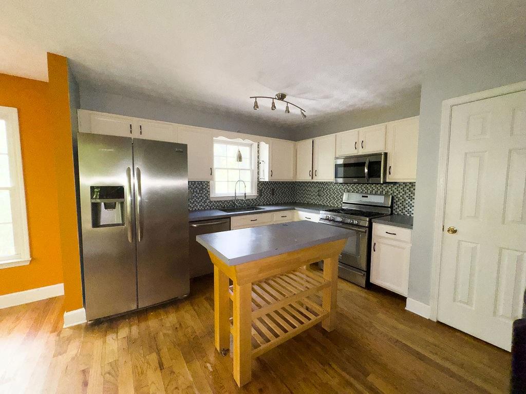 66 Stevenson Point Dallas, GA 30132 - Photo 14 of 39 a kitchen with kitchen island granite countertop a sink cabinets and stainless steel appliances