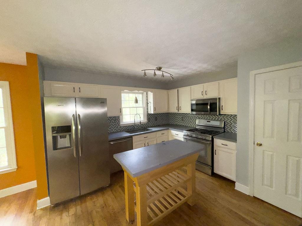 66 Stevenson Point Dallas, GA 30132 - Photo 15 of 39 a kitchen with stainless steel appliances granite countertop a refrigerator a stove and a sink