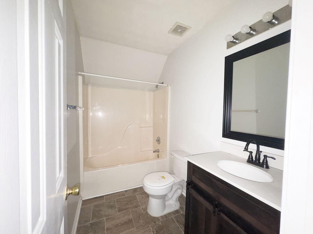 66 Stevenson Point Dallas, GA 30132 - Photo 27 of 39 a bathroom with a granite countertop toilet a sink and a mirror