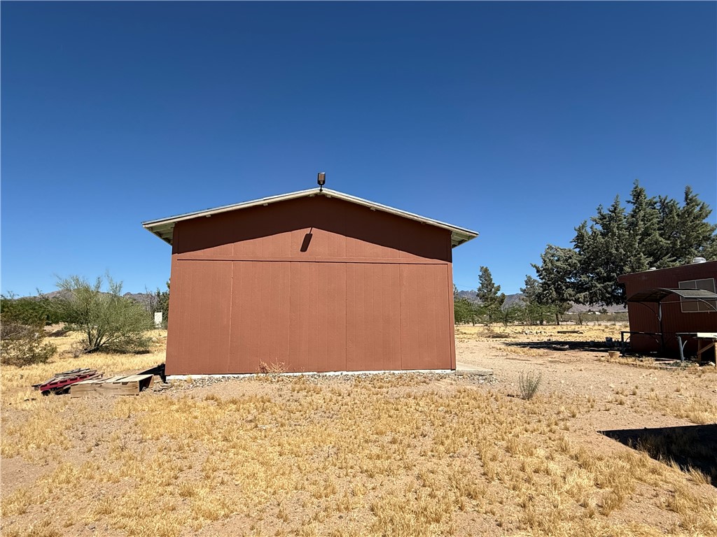 8051 7th Street Dolan Springs, AZ 86441 - Photo 52 of 65 a view of a wooden house with a yard