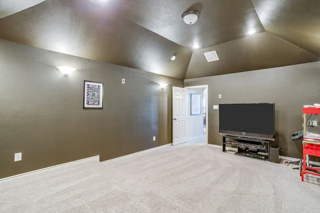 a spacious bedroom with a bed and a large window