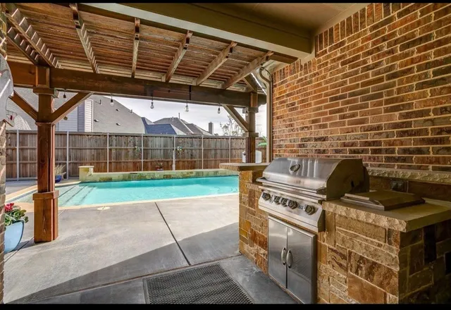 a kitchen with furniture a sink and a stove