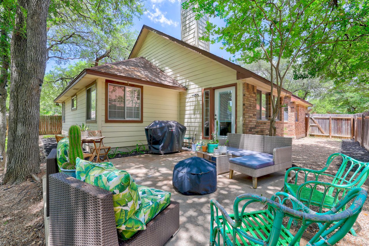 5907 Shanghai Pierce Road Austin, TX 78749 - Photo 26 of 29 Rear view of property with an outdoor living space, a chimney, a fenced backyard, and brick siding