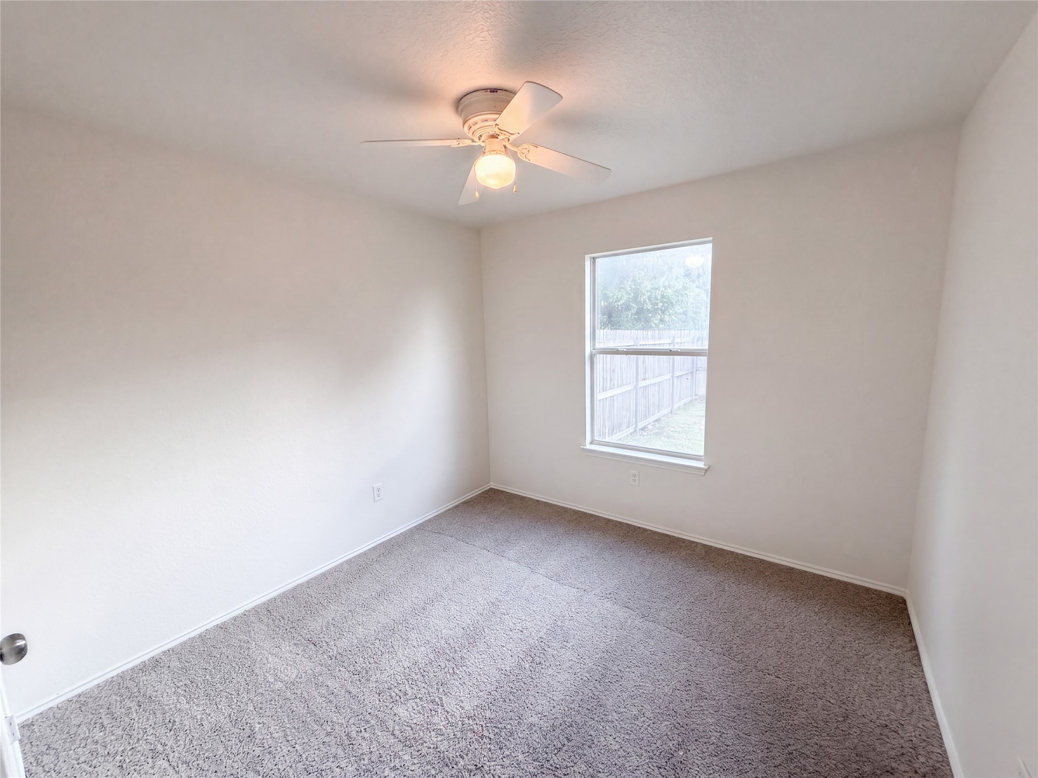 172 Prairie Springs Loop Georgetown, TX 78626 - Photo 17 of 32 Plush carpeting and a large window looking out to the yard define this bedroom.