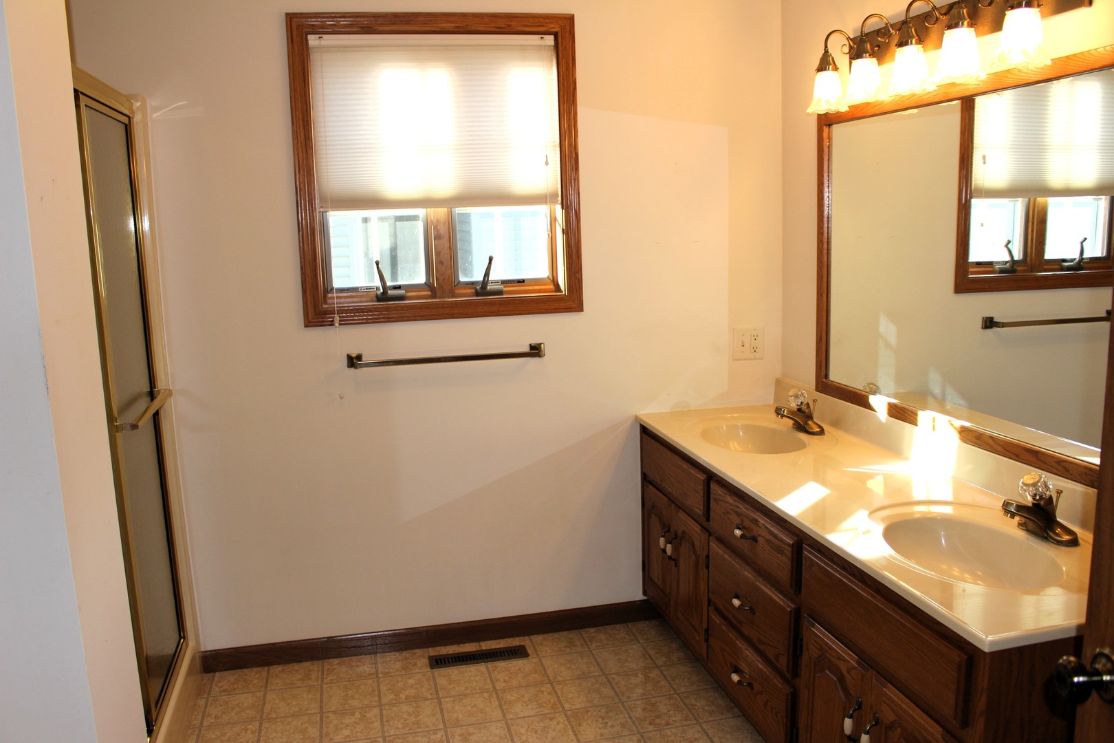 3 Delmar Drive Clinton, IL 61727 - Photo 21 of 44 a bathroom with a double vanity sink and a mirror