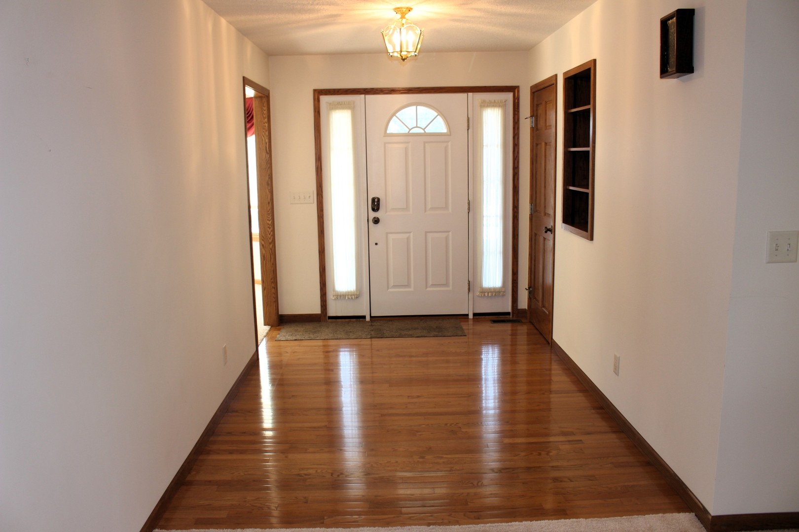 3 Delmar Drive Clinton, IL 61727 - Photo 5 of 44 a view of a hallway with wooden floor and staircase