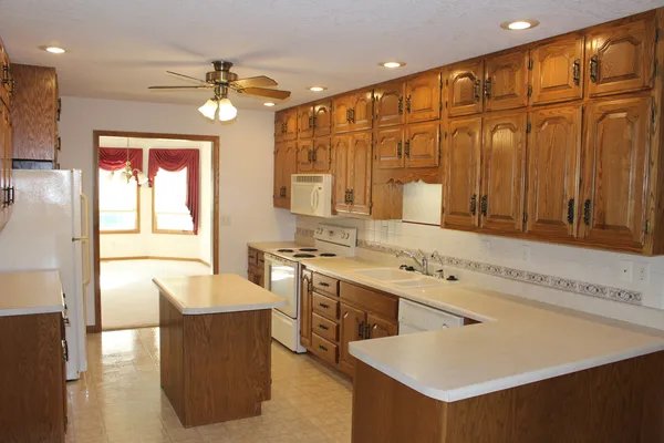 a spacious bathroom with a granite countertop sink and a mirror