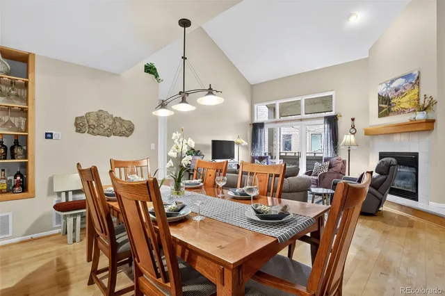 a view of a dining room with furniture a chandelier and wooden floor