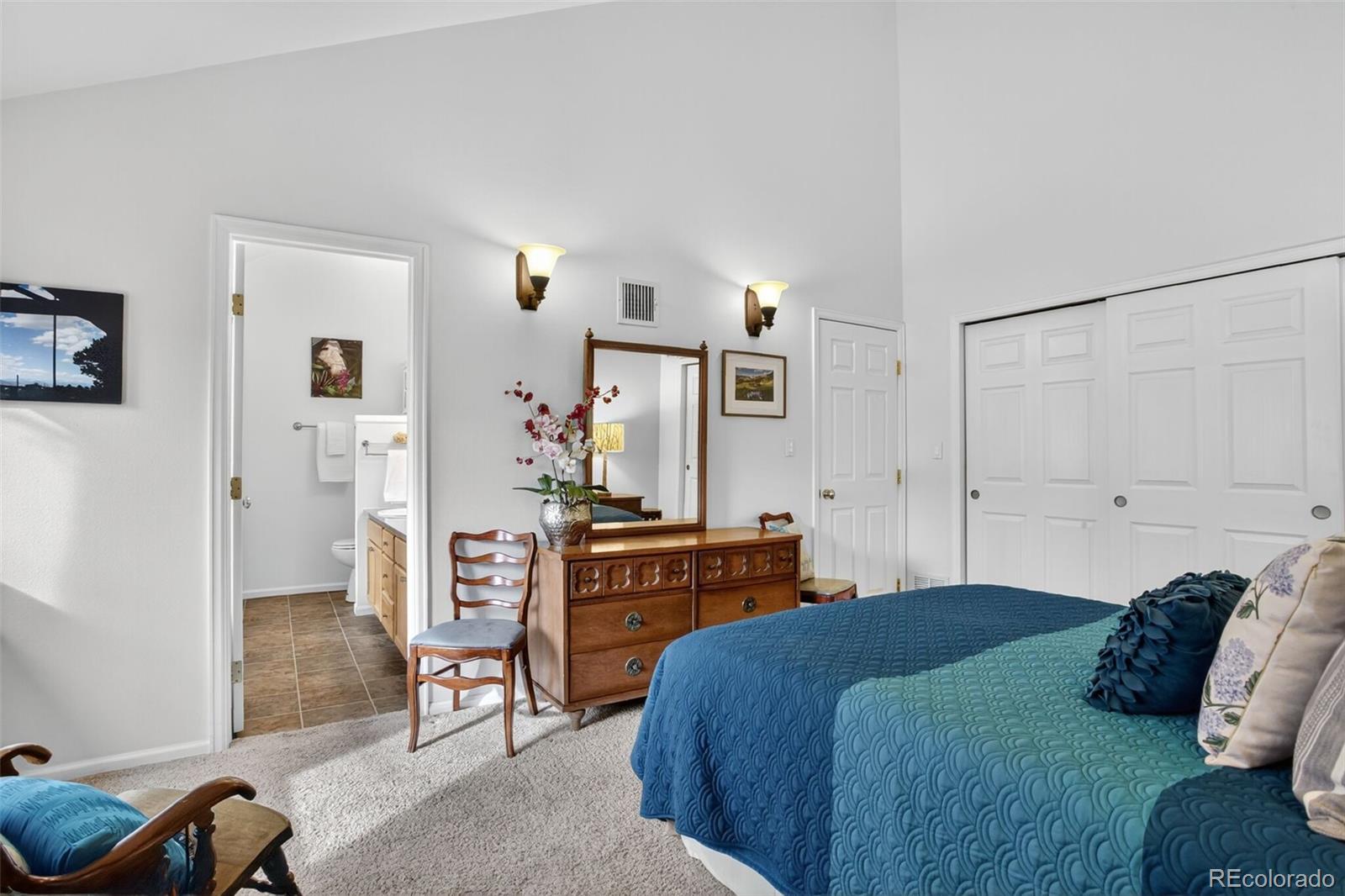 23660 Pondview Place, Unit E Golden, CO 80401 - Photo 13 of 26 a bedroom with a bed and cabinets