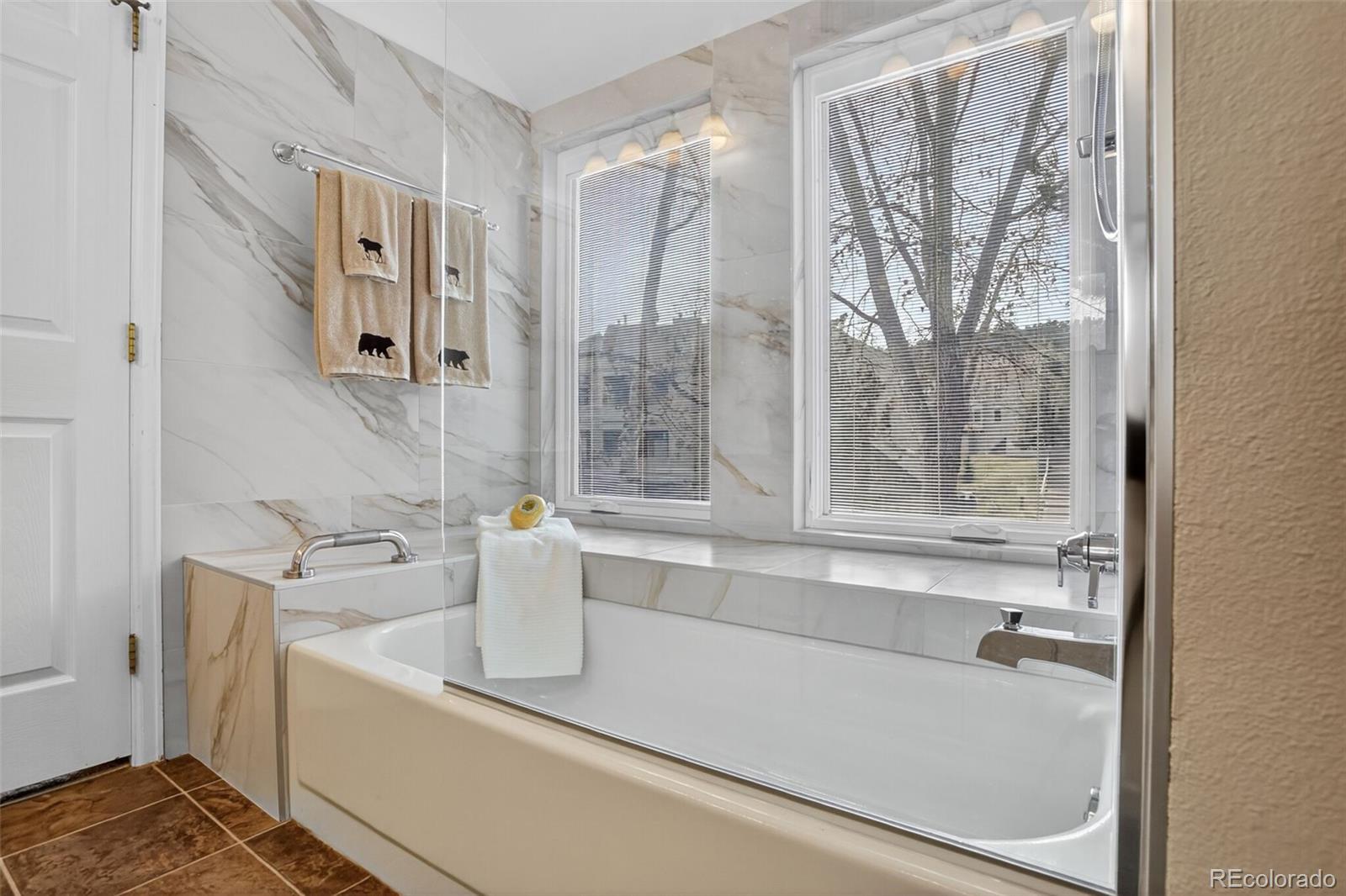 23660 Pondview Place, Unit E Golden, CO 80401 - Photo 15 of 26 a bathroom with bathtub and shower