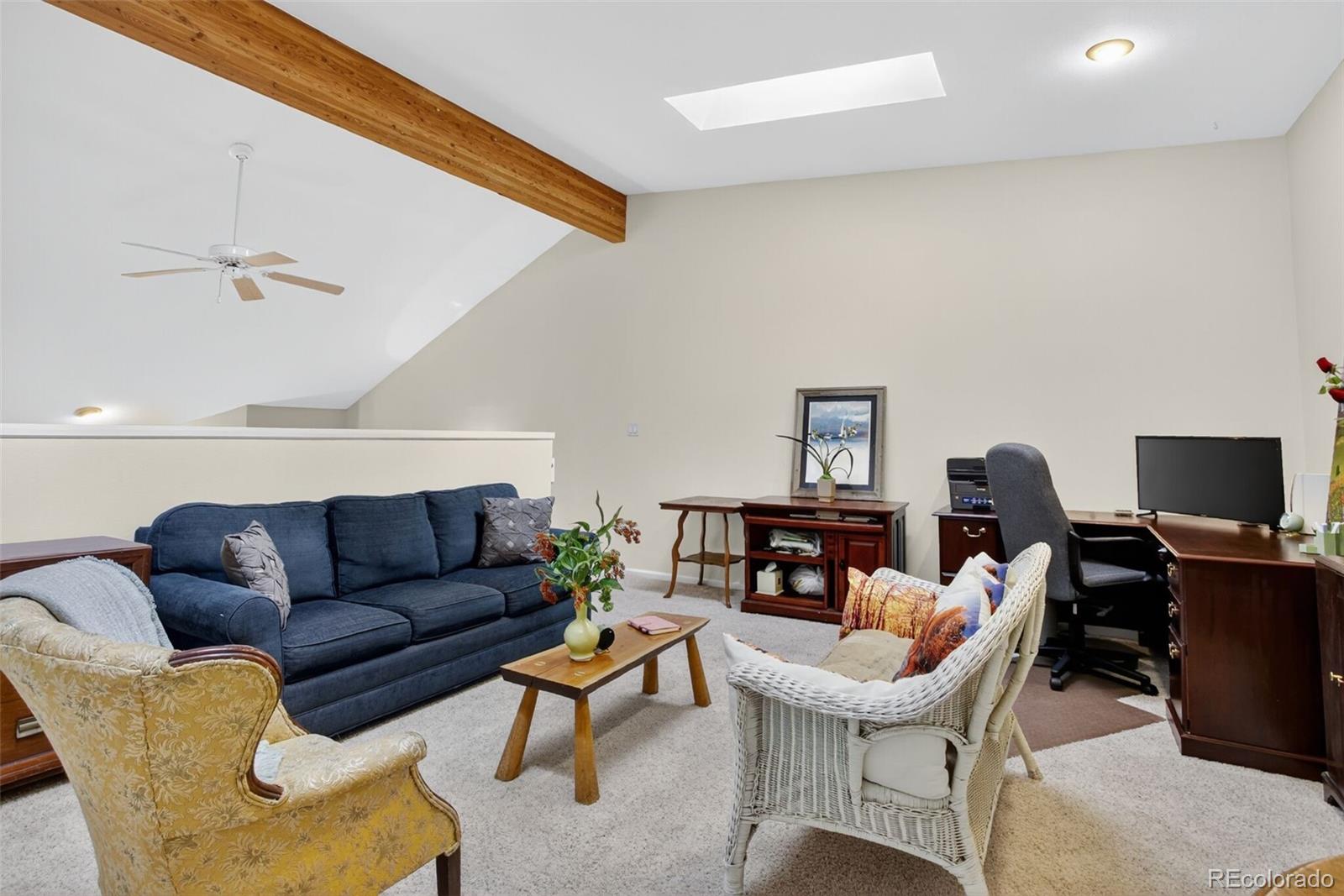 23660 Pondview Place, Unit E Golden, CO 80401 - Photo 19 of 26 a living room with furniture a flat screen tv and a window