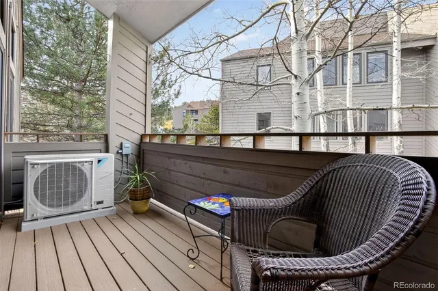 a view of balcony with wooden floor and outdoor seating