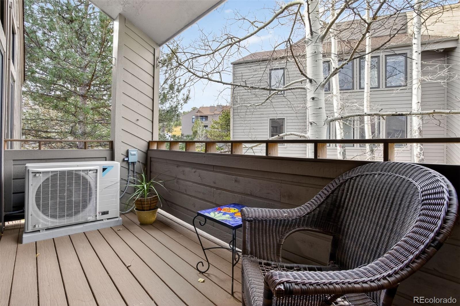 23660 Pondview Place, Unit E Golden, CO 80401 - Photo 22 of 26 a view of balcony with wooden floor and outdoor seating